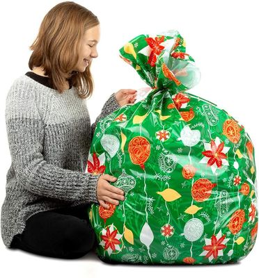 Progetti le borse per il cliente di plastica variopinte dell'involucro di regalo per l'imballaggio enorme del presente di natale
